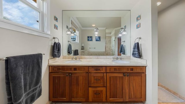 full bath with a sink, double vanity, and crown molding