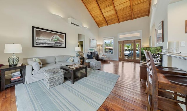 living area featuring high vaulted ceiling, beamed ceiling, hardwood / wood-style floors, a wall mounted AC, and wooden ceiling