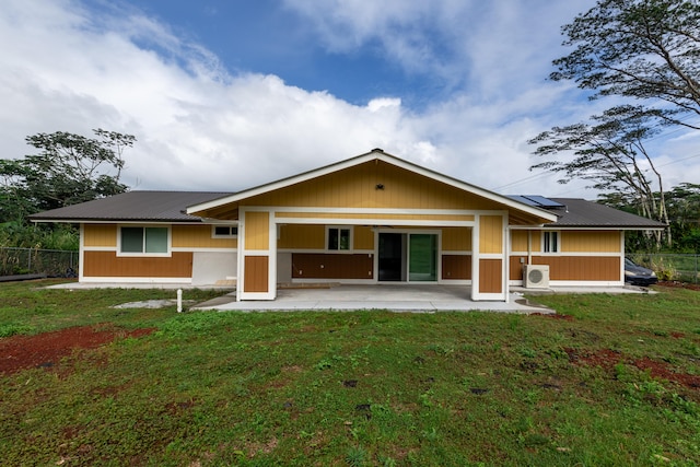 back of house featuring a patio, solar panels, metal roof, and ac unit