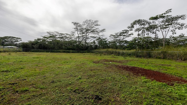 view of yard featuring fence and a rural view