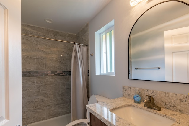 bathroom featuring plenty of natural light, toilet, curtained shower, and vanity