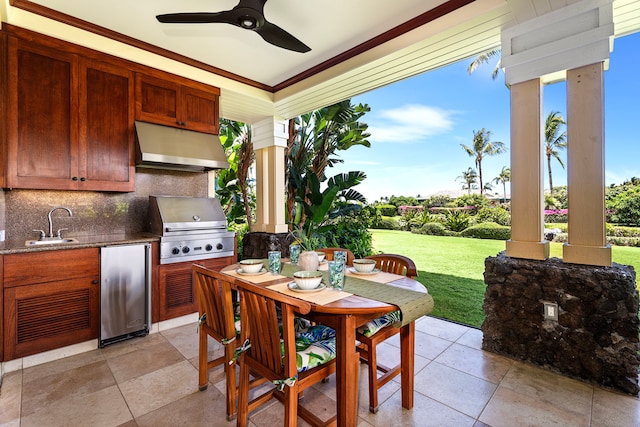 view of patio / terrace with outdoor dining area, a sink, ceiling fan, area for grilling, and an outdoor kitchen