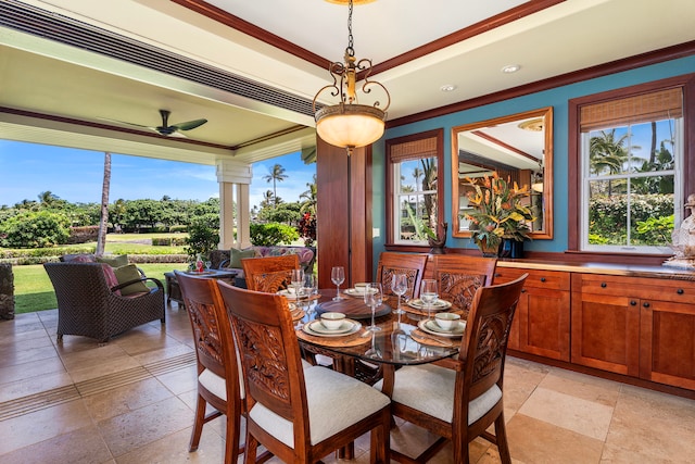 dining area featuring a raised ceiling, plenty of natural light, a ceiling fan, and ornamental molding