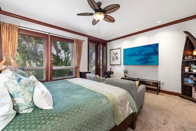 carpeted bedroom with baseboards, a ceiling fan, and crown molding