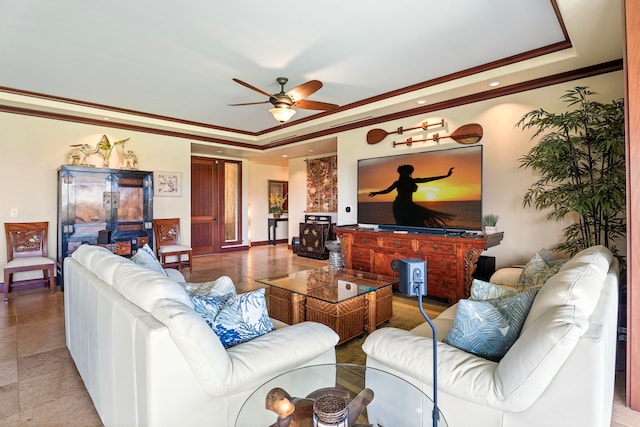 living room with recessed lighting, ornamental molding, baseboards, a raised ceiling, and a ceiling fan