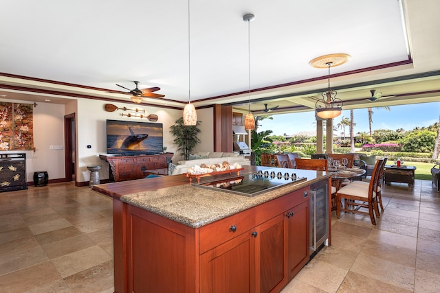 kitchen featuring beverage cooler, black electric stovetop, a center island, pendant lighting, and open floor plan