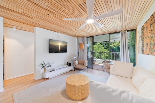 1875 Kalanianaole Ave Unit 311, Hilo, HI 96720 - living room with expansive windows, a ceiling fan, wood ceiling, wood finished floors, and baseboards