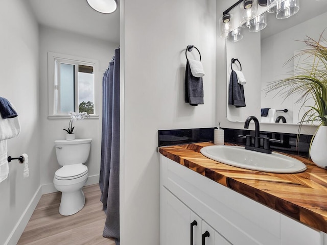 2427 Kaiwiki Rd, Hilo, HI 96720 - full bath featuring toilet, vanity, wood finished floors, and baseboards