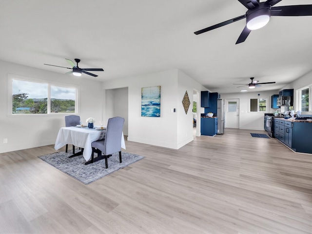 2427 Kaiwiki Rd, Hilo, HI 96720 - dining room featuring a ceiling fan, light wood-style flooring, and baseboards