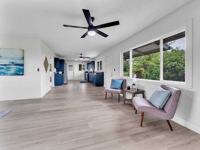 2427 Kaiwiki Rd, Hilo, HI 96720 - living area featuring ceiling fan, light wood-style flooring, and baseboards
