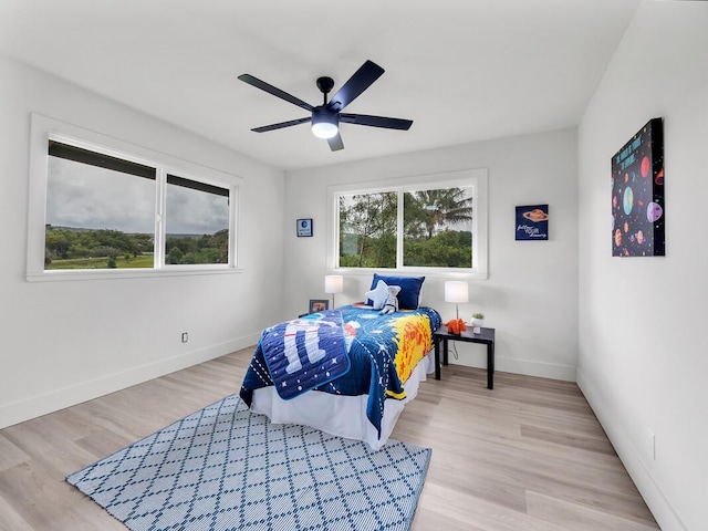 2427 Kaiwiki Rd, Hilo, HI 96720 - bedroom with baseboards, light wood-type flooring, and a ceiling fan