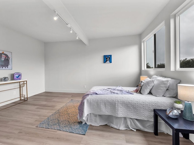 2427 Kaiwiki Rd, Hilo, HI 96720 - bedroom featuring rail lighting, wood finished floors, and baseboards