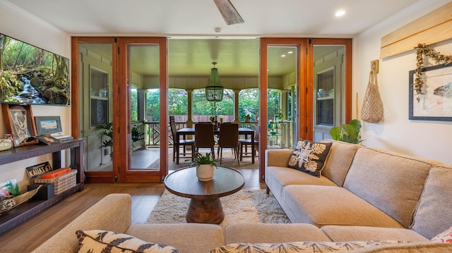 living room featuring crown molding, recessed lighting, and wood finished floors