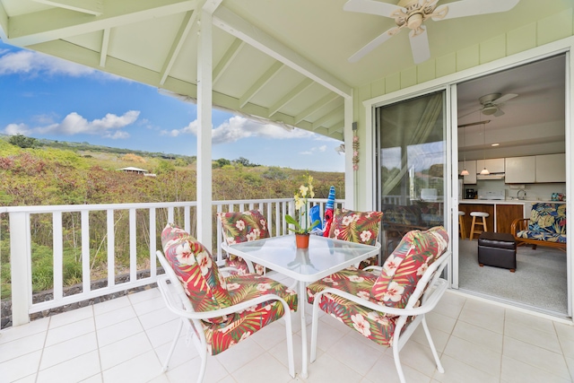 balcony with a ceiling fan and outdoor dining area