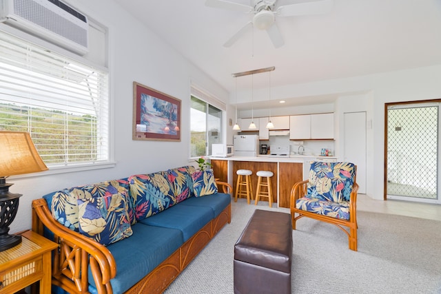living area with ceiling fan, a wall mounted AC, and light carpet