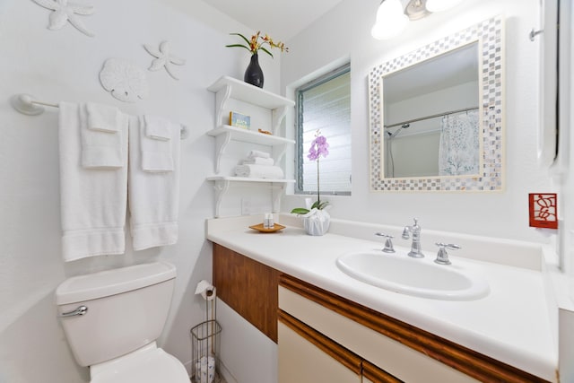 full bathroom with toilet and vanity