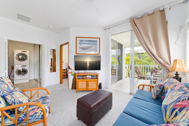 carpeted living area with visible vents and stacked washer and dryer