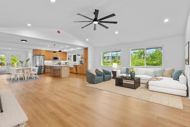 living area with vaulted ceiling, recessed lighting, french doors, light wood-style floors, and ceiling fan