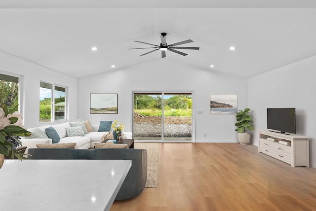 living area featuring healthy amount of natural light, light wood-type flooring, lofted ceiling, a ceiling fan, and recessed lighting