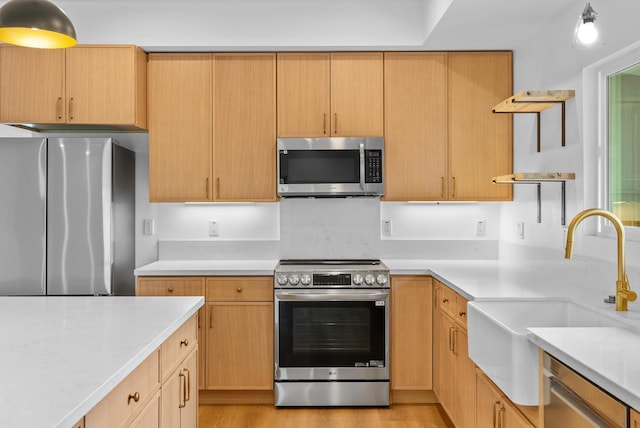 kitchen with appliances with stainless steel finishes, a sink, and open shelves