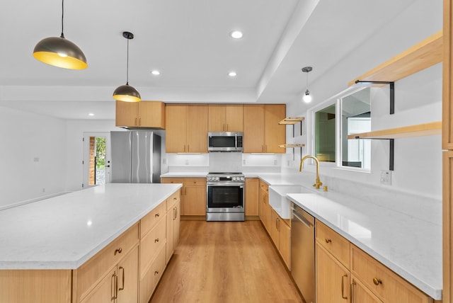 kitchen featuring appliances with stainless steel finishes, a sink, light wood-type flooring, light brown cabinetry, and recessed lighting