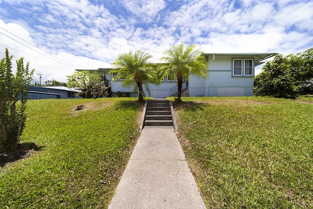 view of front of home featuring a front yard and stairs