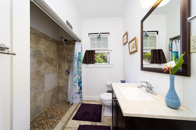 bathroom featuring tiled shower, vanity, toilet, and crown molding