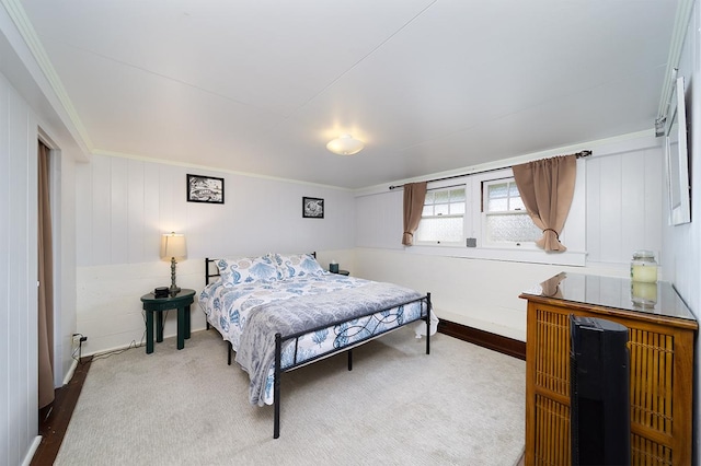 carpeted bedroom featuring crown molding and baseboards
