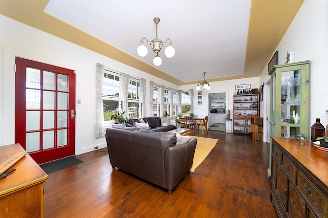 living room featuring a chandelier and dark wood-style floors