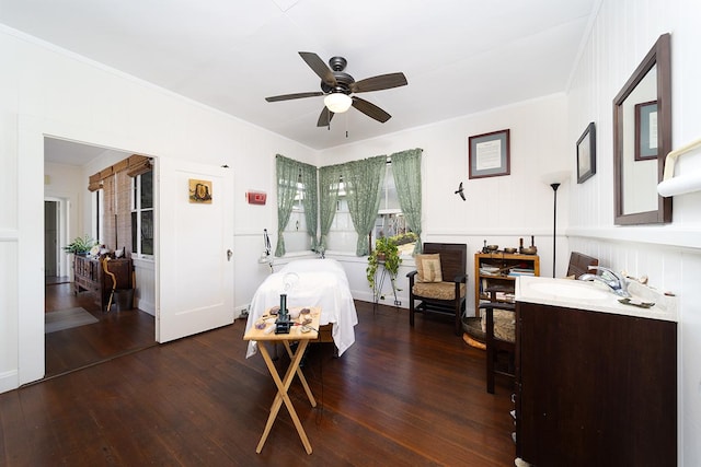 bedroom with dark wood-type flooring, a sink, and crown molding