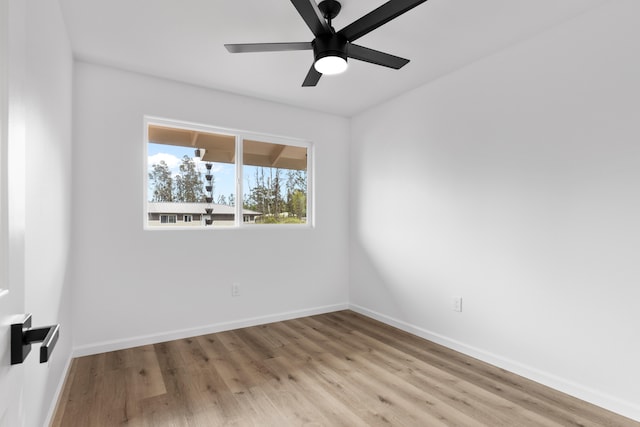 spare room with baseboards, a ceiling fan, and wood finished floors