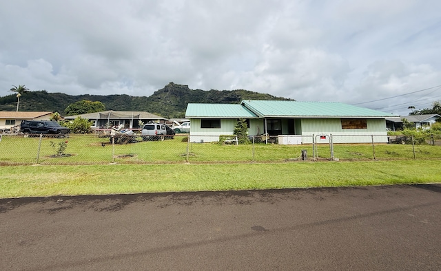 325 Kihapai St, Kapaa, HI 96746 - ranch-style home with a mountain view, fence private yard, a front lawn, and metal roof