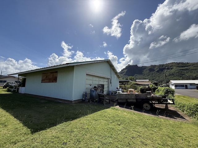325 Kihapai St, Kapaa, HI 96746 - view of home's exterior with a detached garage, an outdoor structure, and a lawn