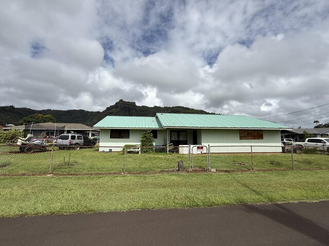 325 Kihapai St, Kapaa, HI 96746 - view of front of property featuring metal roof, a front lawn, and a fenced front yard