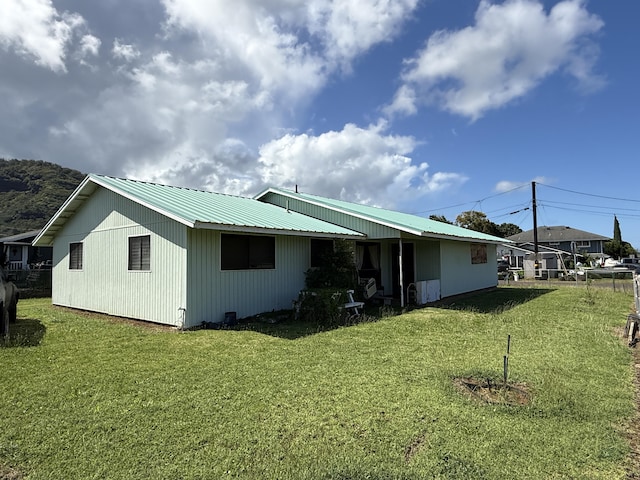 325 Kihapai St, Kapaa, HI 96746 - back of property featuring metal roof and a lawn