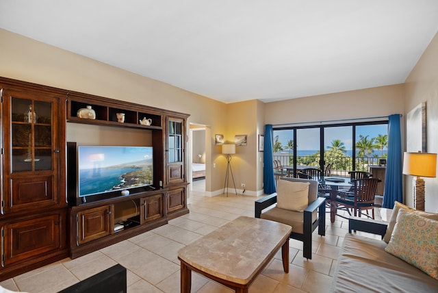 living area featuring baseboards and light tile patterned floors