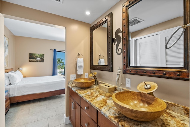 ensuite bathroom featuring recessed lighting, tile patterned floors, double vanity, visible vents, and ensuite bath