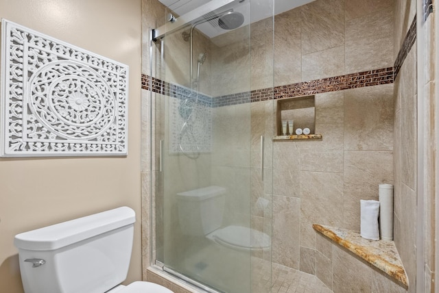 bathroom with toilet and a stall shower
