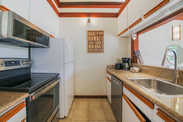 2253 Poipu Rd Unit 148, Koloa, HI 96756 - kitchen with appliances with stainless steel finishes, white cabinets, a sink, and light tile patterned floors
