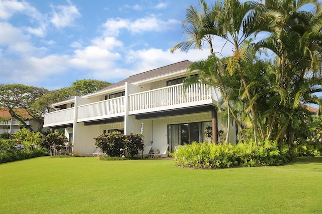 2253 Poipu Rd Unit 148, Koloa, HI 96756 - rear view of property featuring a lawn and a balcony
