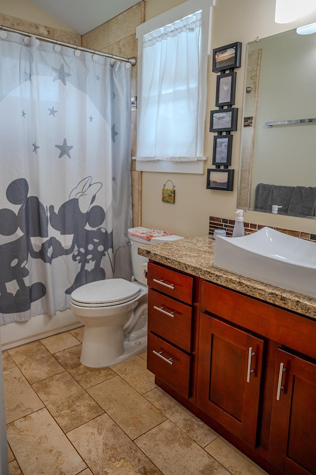 full bathroom with toilet, vanity, and shower / bathtub combination with curtain