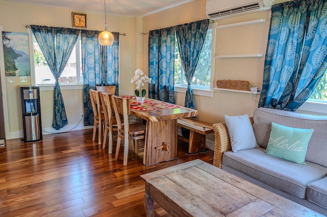 dining area featuring wood finished floors and a wall unit AC