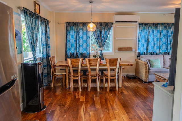dining area with wood finished floors, a wealth of natural light, and a wall mounted air conditioner