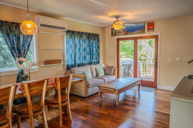 living area with a ceiling fan, wood finished floors, and a wall unit AC