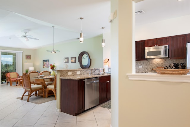 69-200 Pohakulana Pl Unit A31, Waikoloa, HI 96738 - kitchen with appliances with stainless steel finishes, decorative backsplash, a peninsula, light tile patterned floors, and a sink