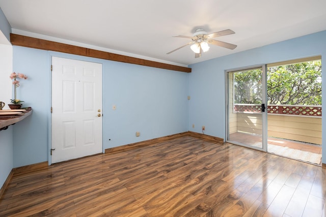 empty room featuring a ceiling fan and wood finished floors