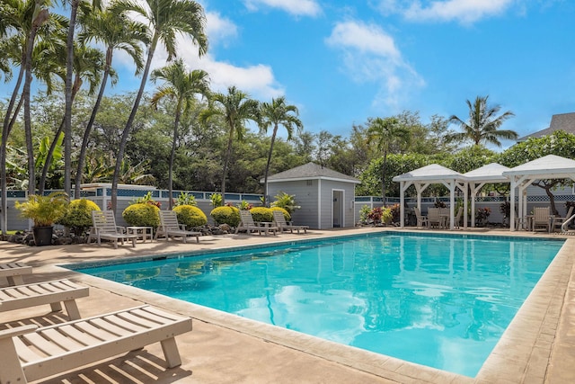 pool featuring fence, a gazebo, and a patio area