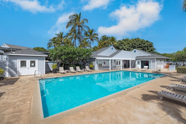 community pool featuring a patio area and fence