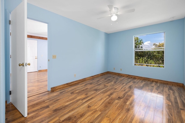spare room featuring ceiling fan and wood finished floors