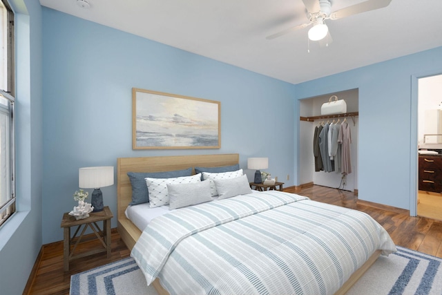 bedroom featuring a closet, a ceiling fan, baseboards, and wood finished floors